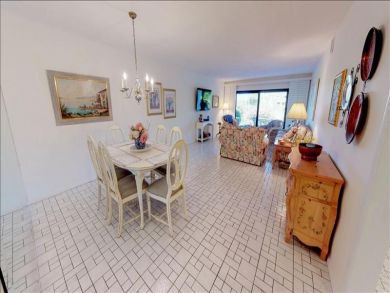 Just Steps to the Sandy Beach from this Two Bedroom Condo